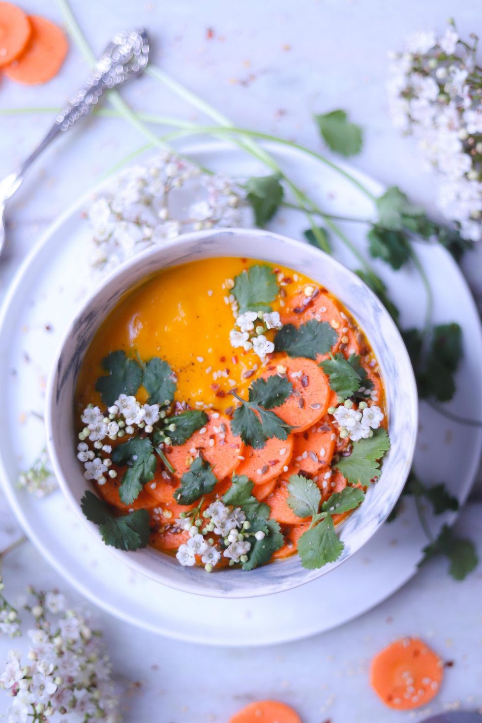 A bowl of soup is garnished with cilantro.