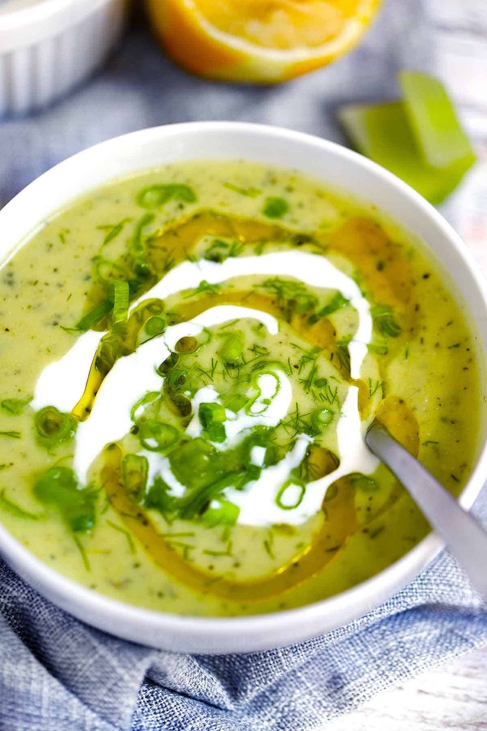 A bowl of soup is on a blue cloth.