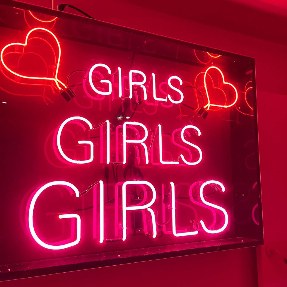 a pink and red neon sign with hearts that says "girls, girls, girls"