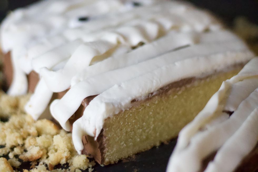 A slice of No-Bake Halloween Sponge Cake decorated as a mummy