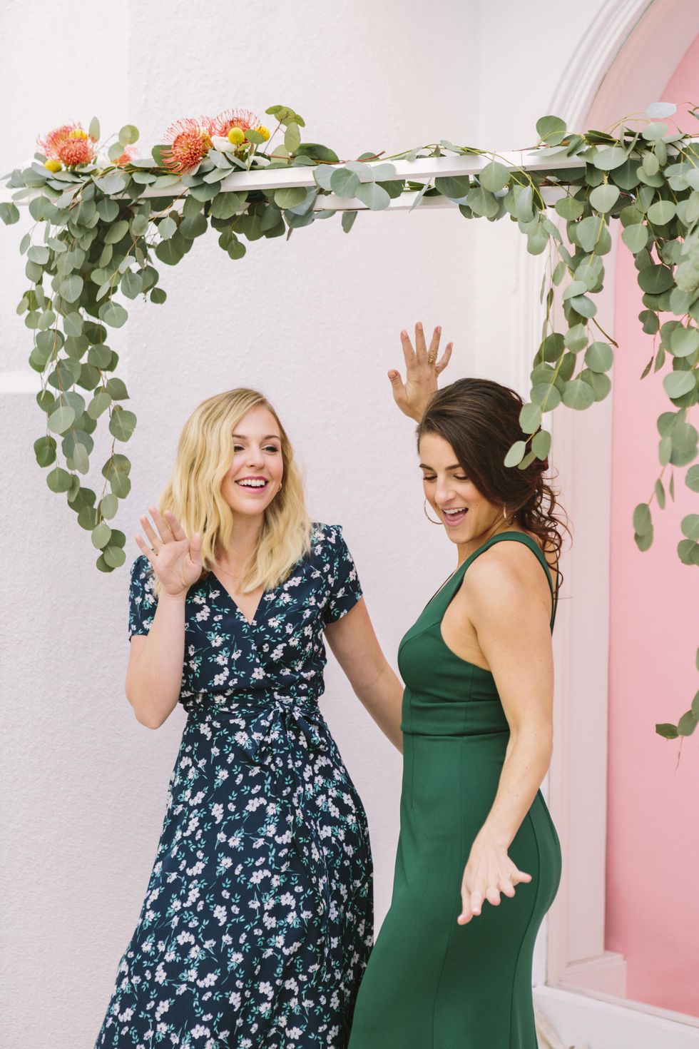 a wedding guest and a bridesmaid dancing under an arbor going to a wedding single