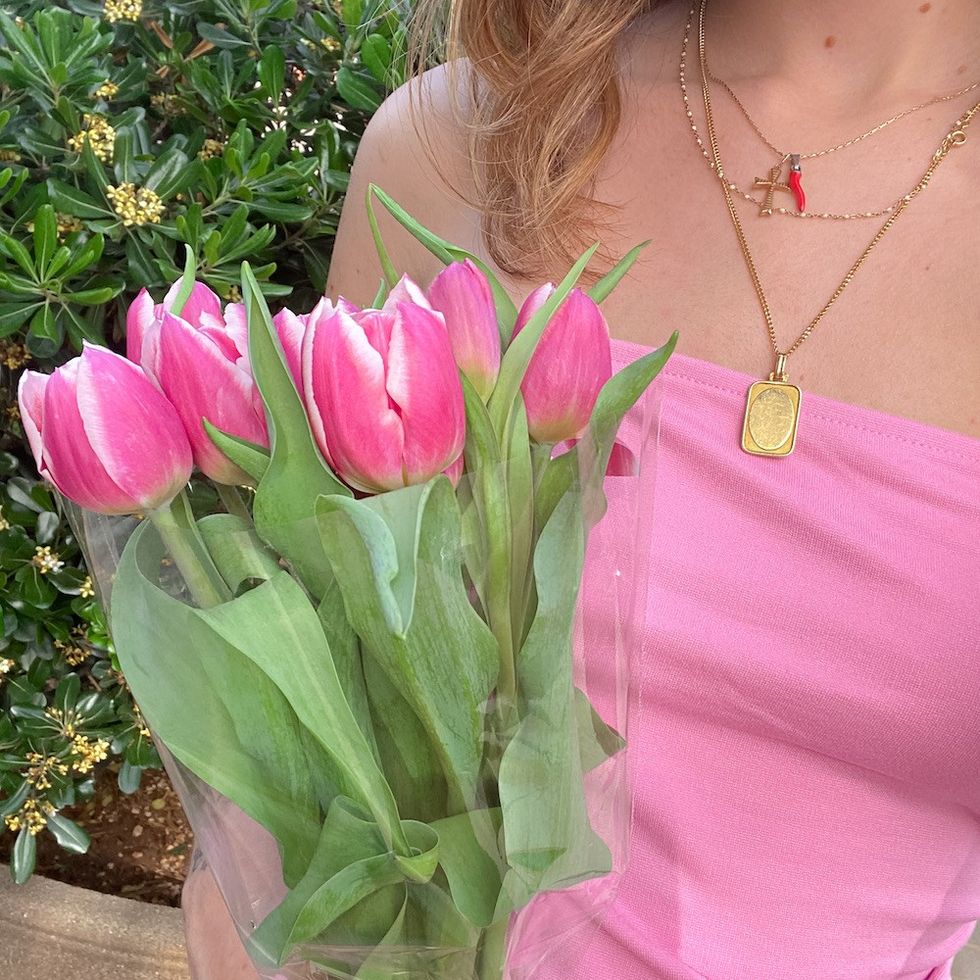 a woman carrying pink tulips