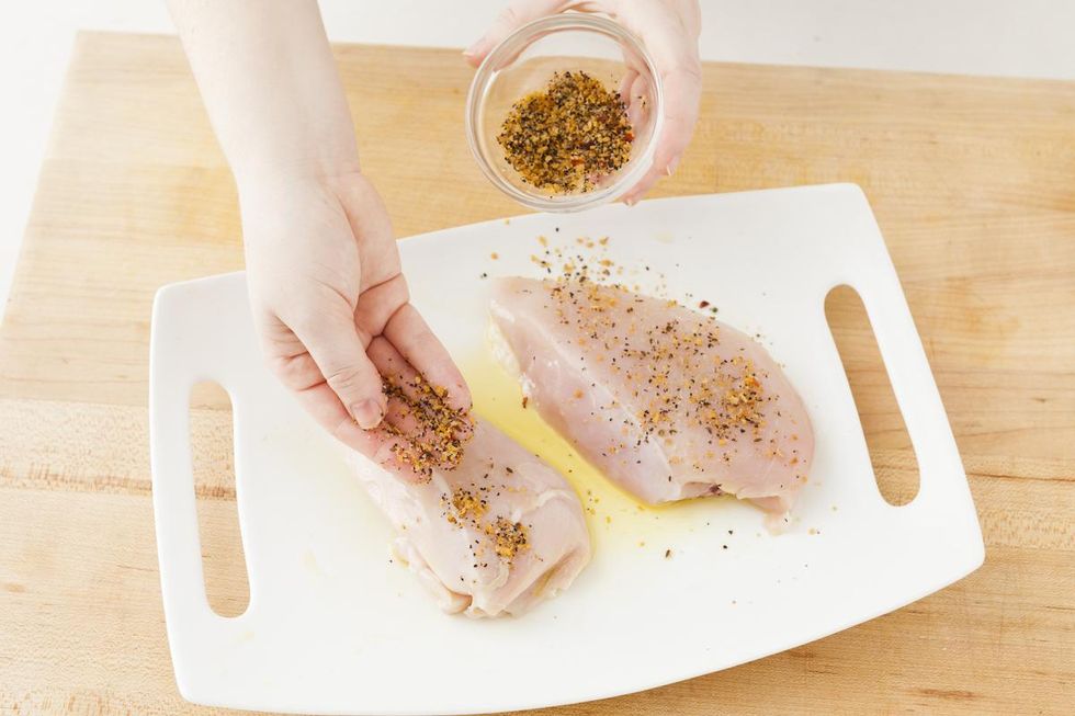 adding a spice rub to chicken breasts