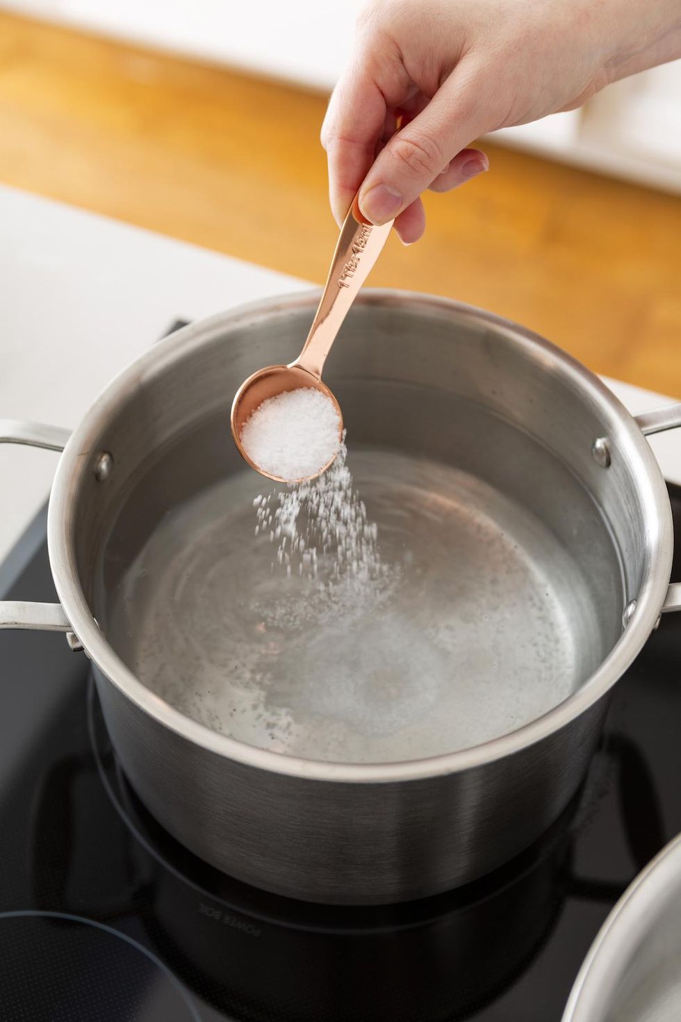 adding salt to boiling water pickled vegetables