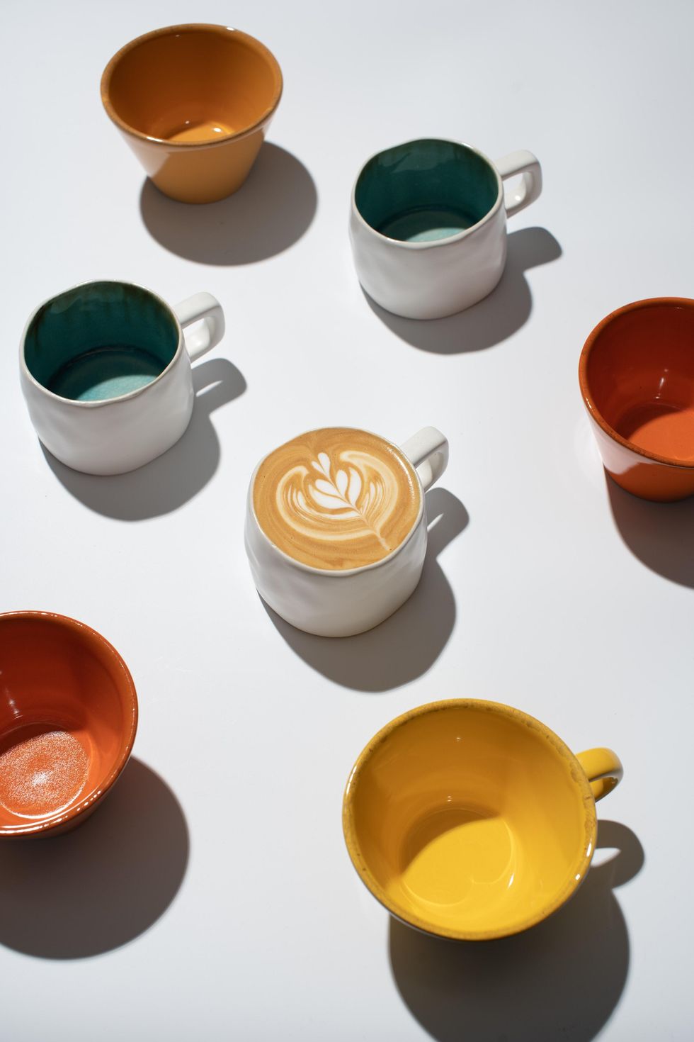 colorful mugs and latte art