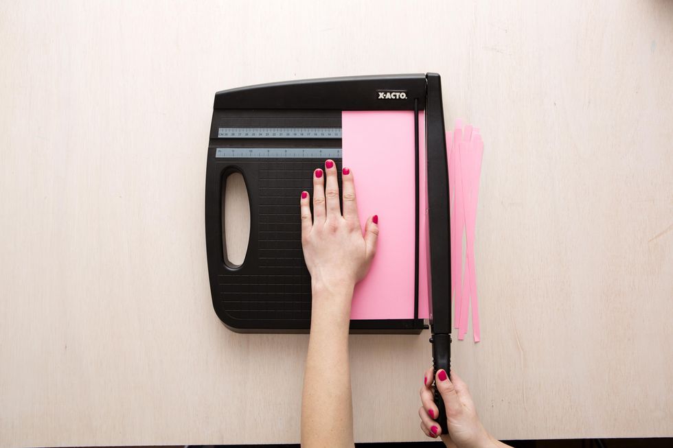 cutting strips of pink paper