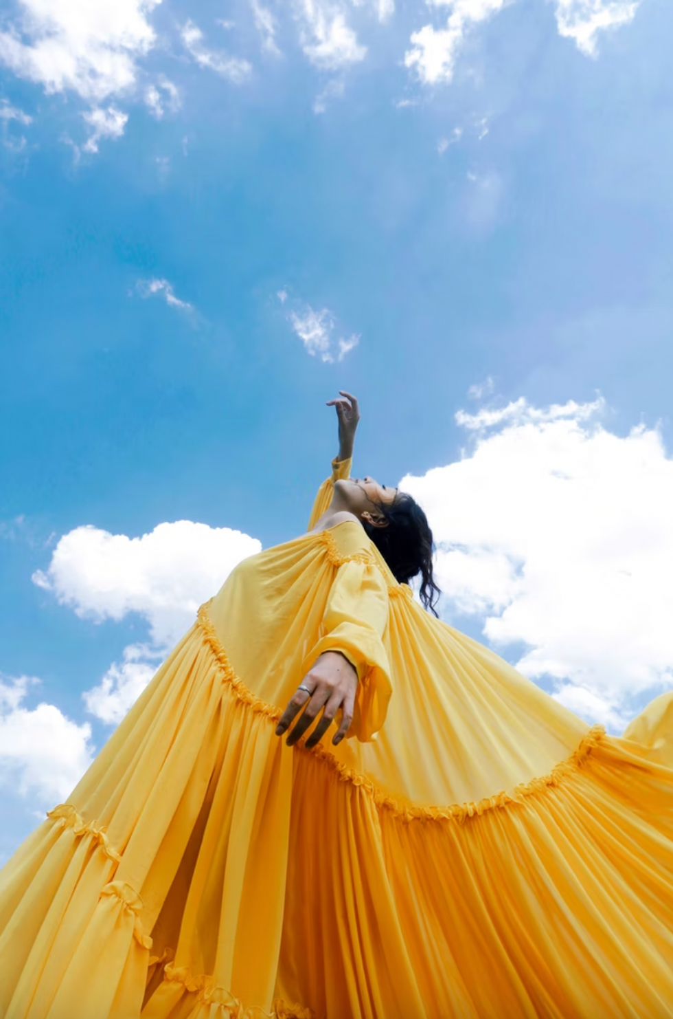 dopamine dressing girl in yellow dress against the blue sky