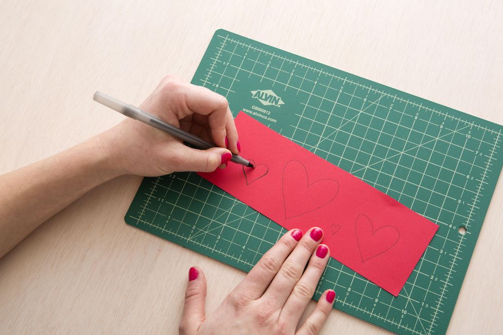 drawing hearts onto red paper