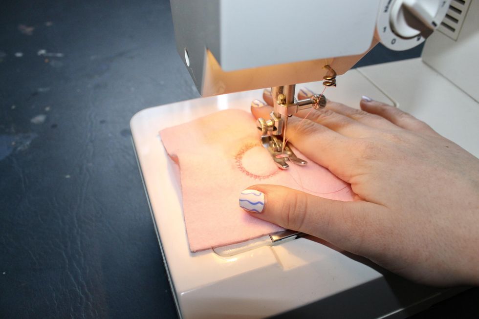 embroidering the sun into the fleece