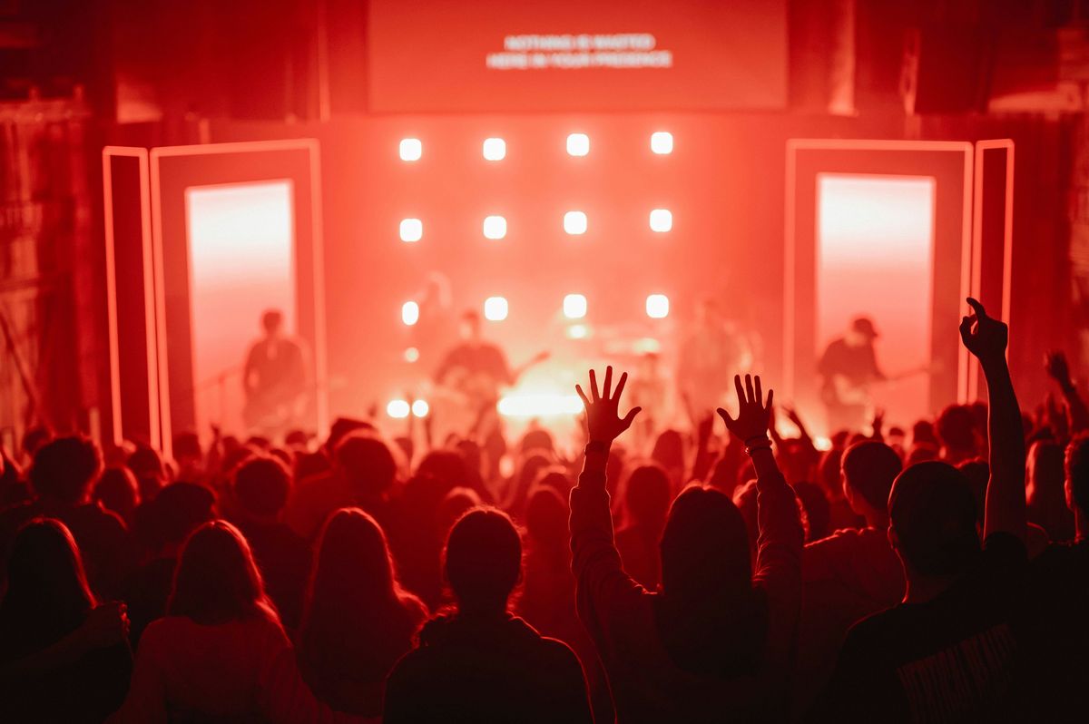 Experience gift ideas A crowd of people at a concert with their hands in the air