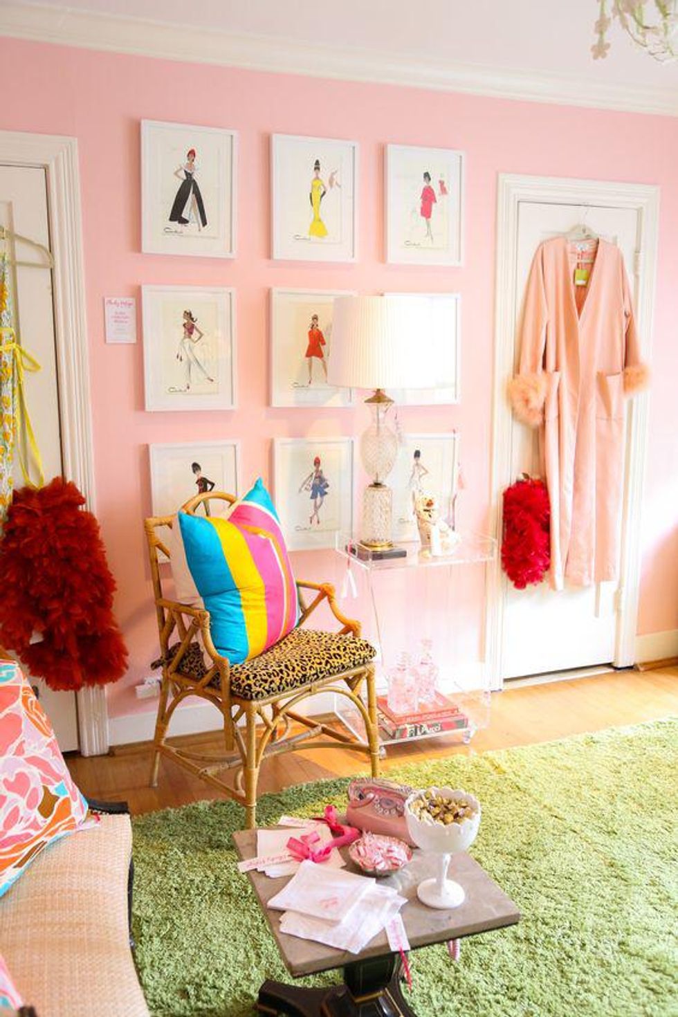 pink walls with green carpet and colorful gallery wall