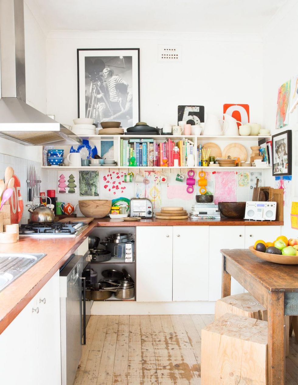 rainbow bookshelf in white kitchen