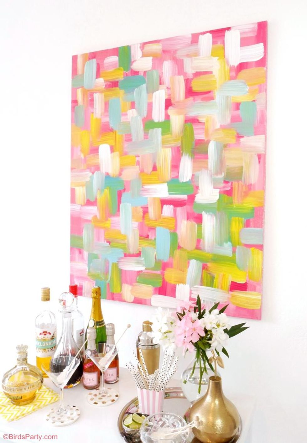 colorful wall art hanging on a white wall with brush strokes going in all different directions