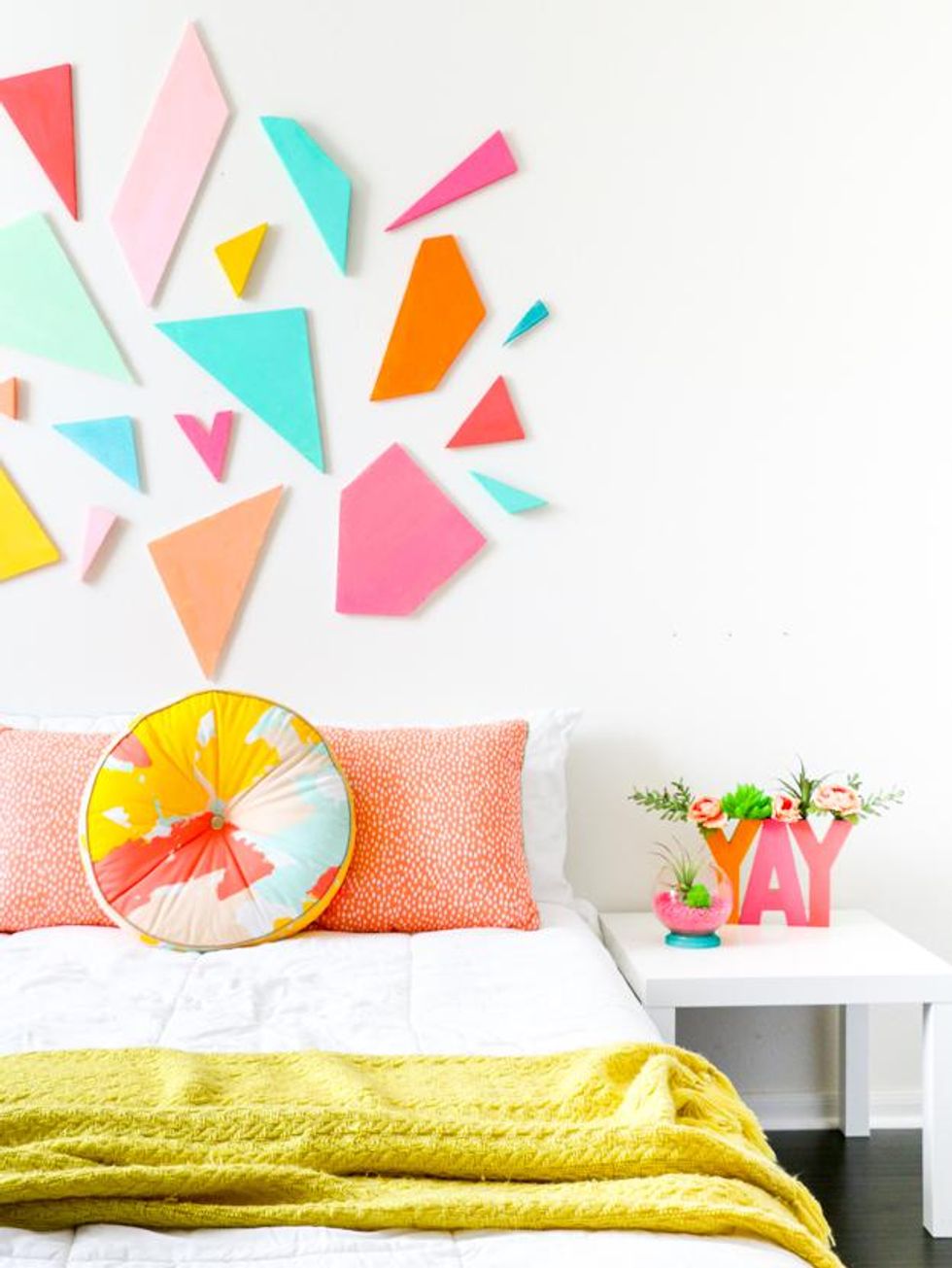 geometric headboard with pink, blue, and orange tiles