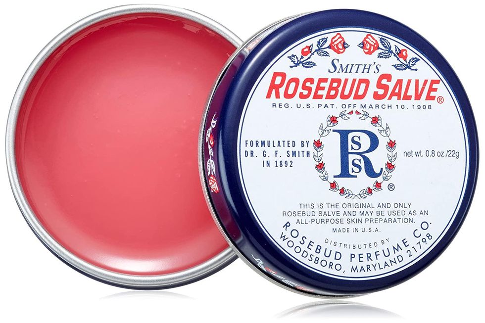 pink rosebud salve in a white, blue, and pink tin