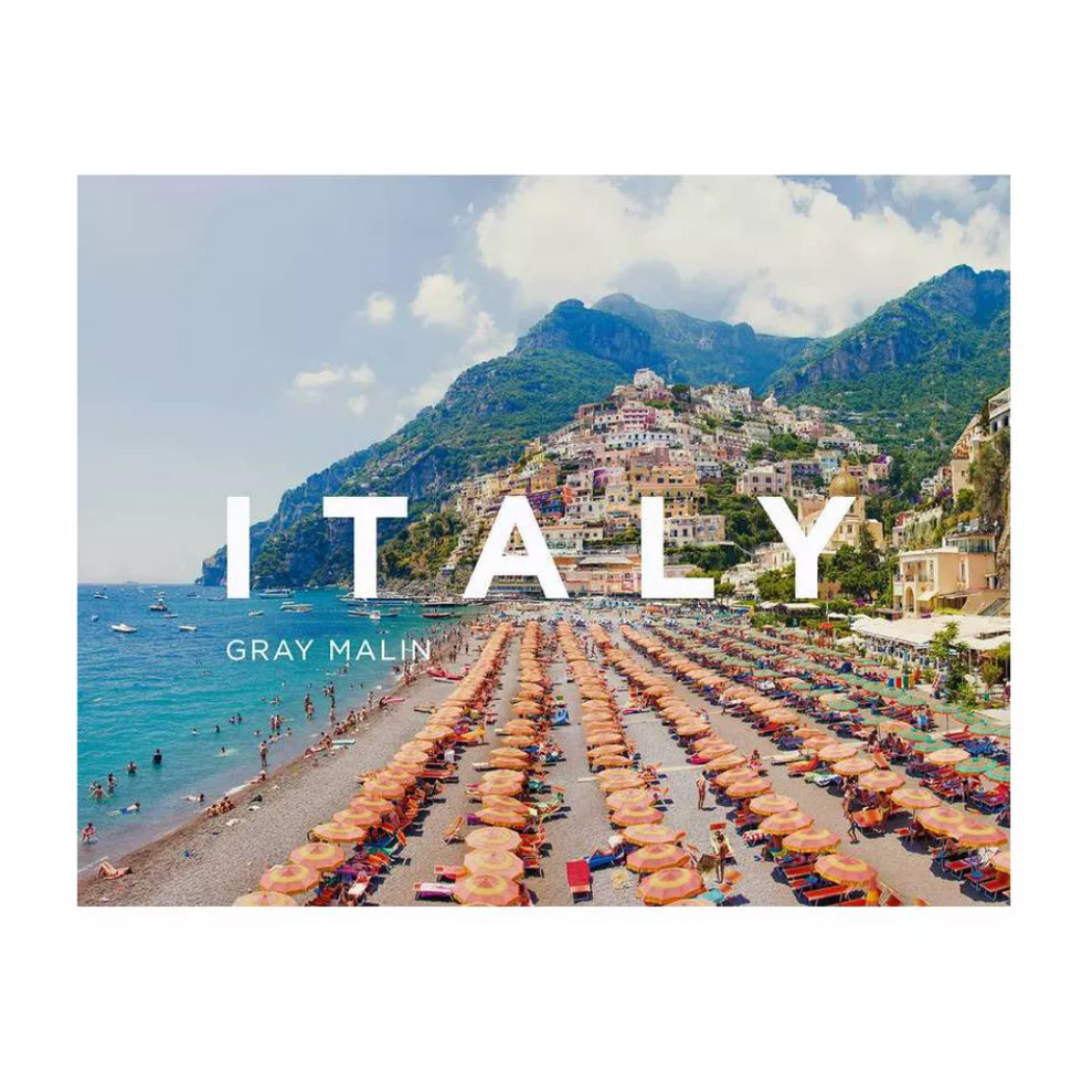 italian beach with lots of beach umbrellas and white writing