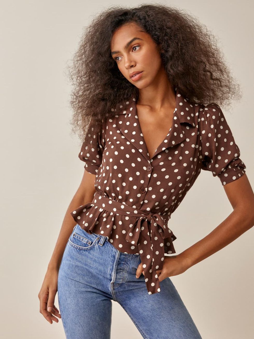 brown and white polka dot top from reformation with bow waist and button front