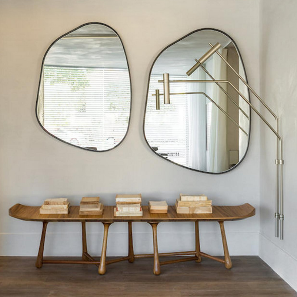 pair of Aesthetic Asymmetrical Mirror hanging on the wall