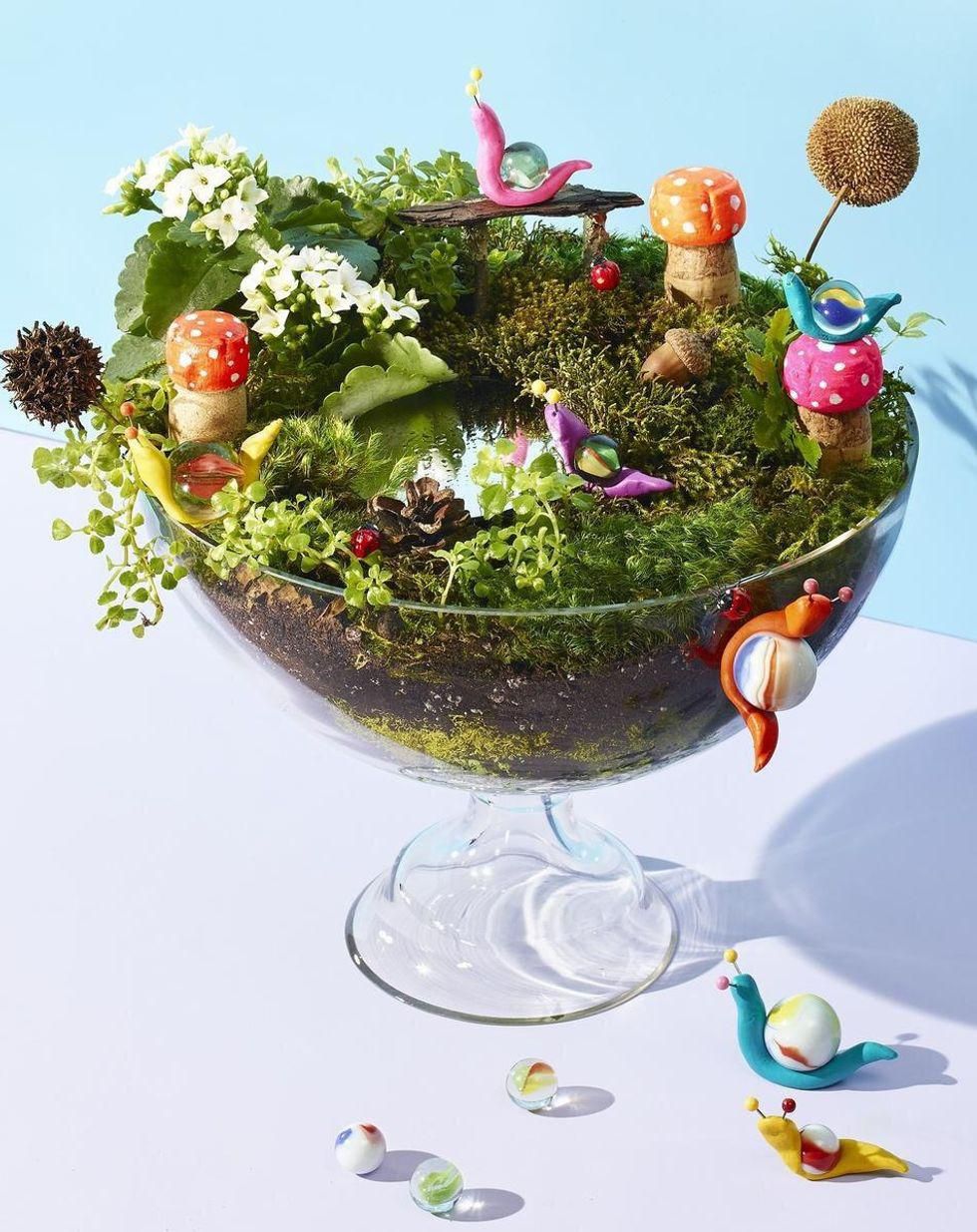 goblincore fairy garden in a glass container