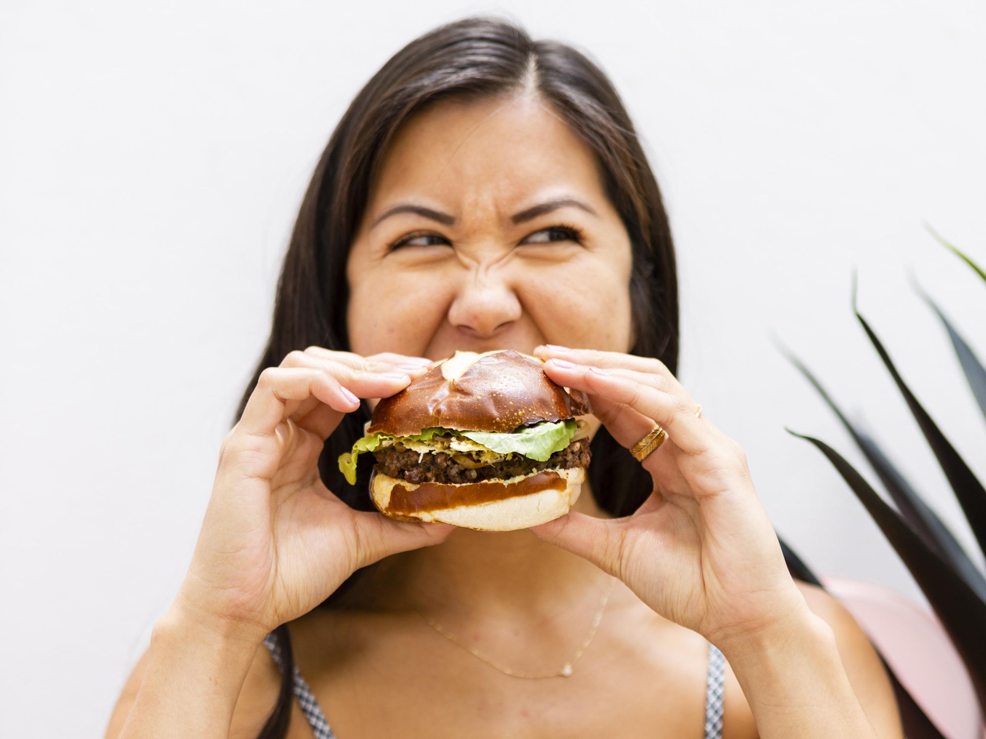 girl bites into a burger