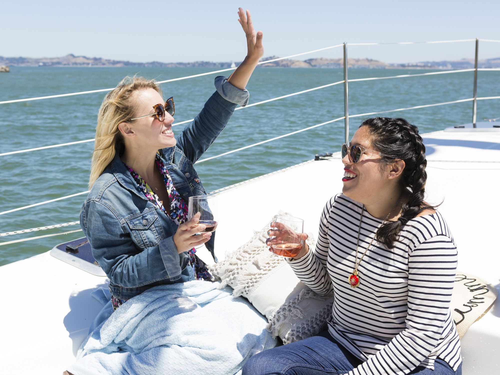 models sit on a boat drinking rose