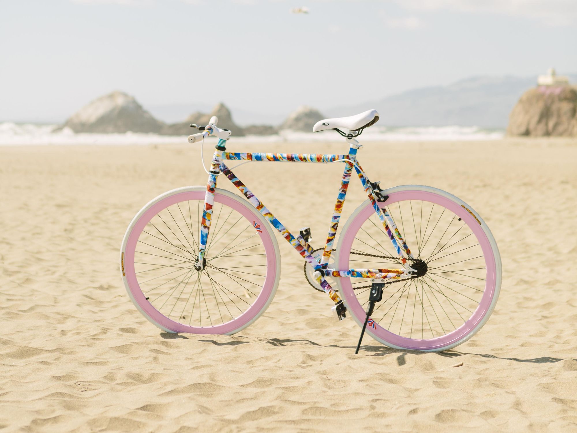 colorful bike sits on the beach