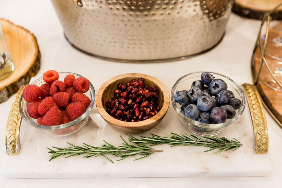 bowls of berries and pomegranate seeds