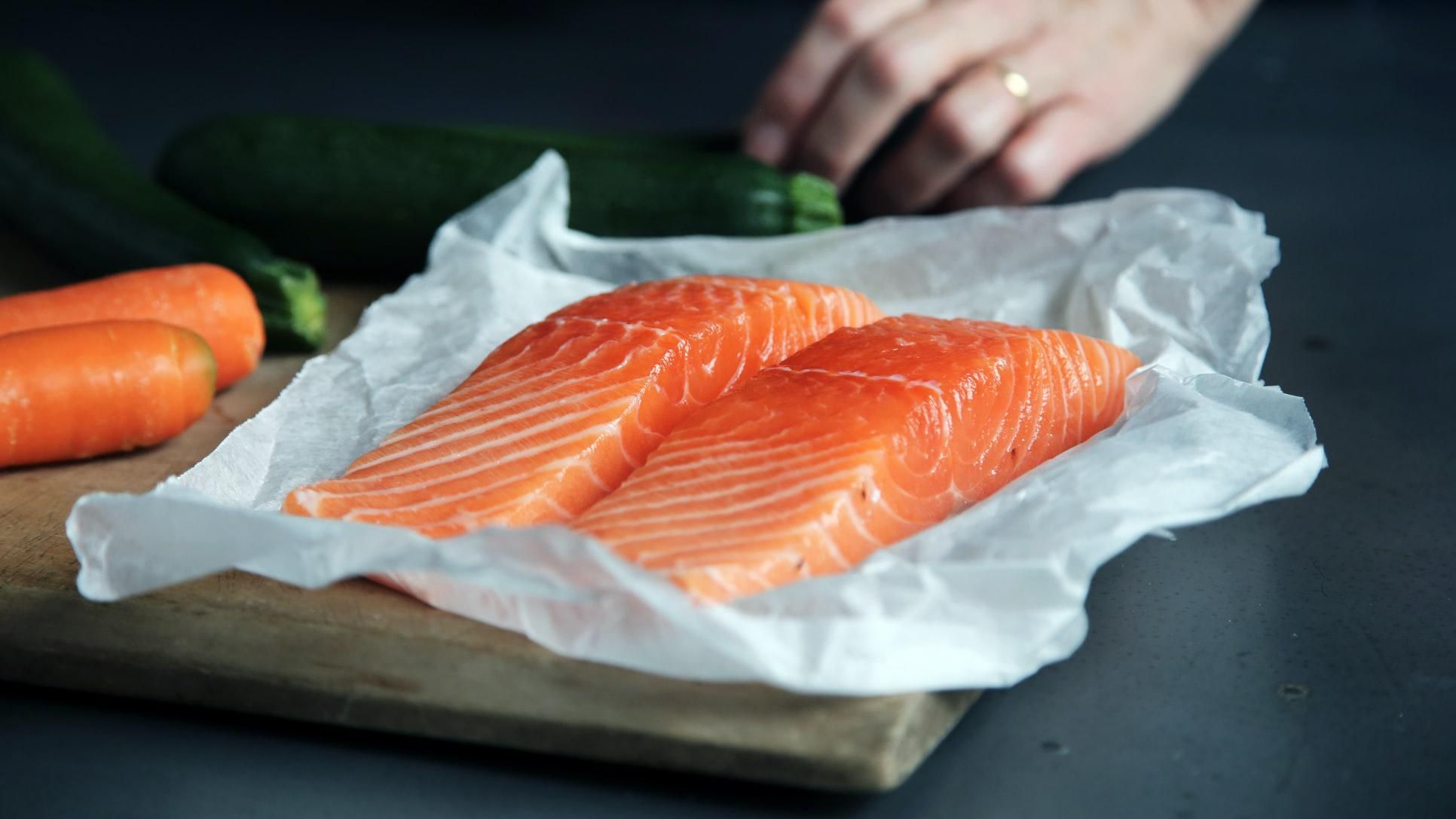 filets of raw salmon on a cutting board