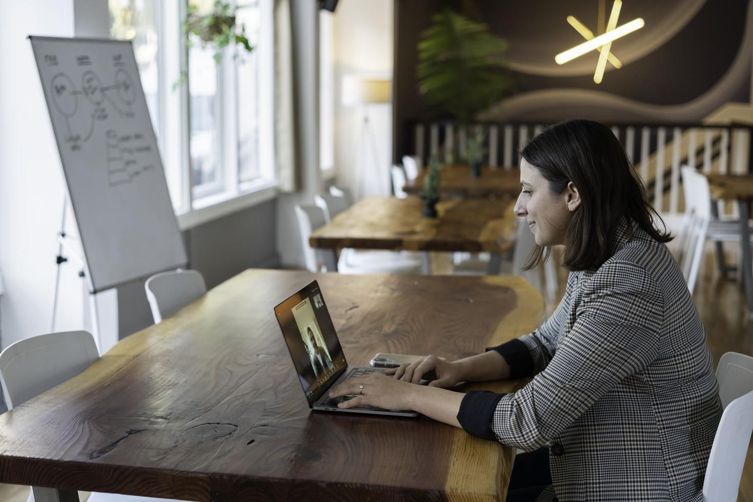 woman in gray plaid blazer on a zoom call