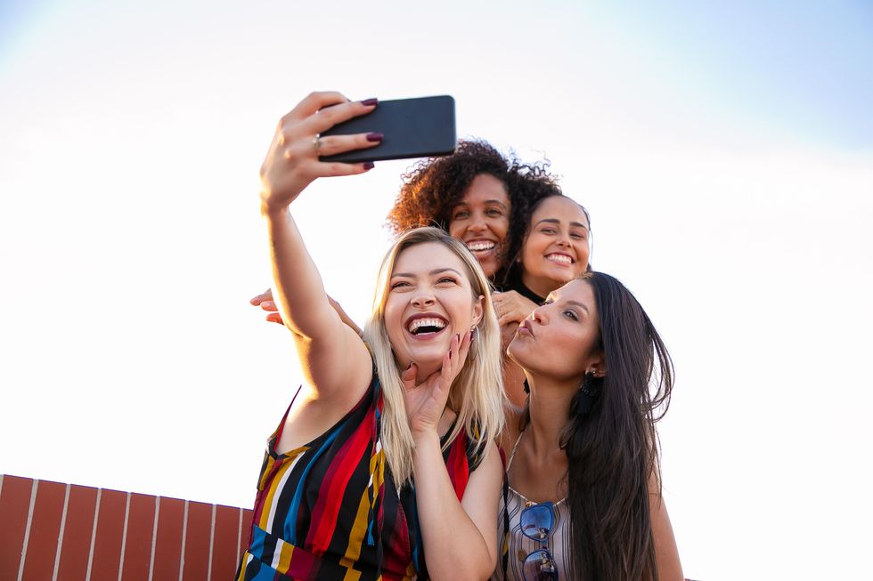 four women taking a selfie together