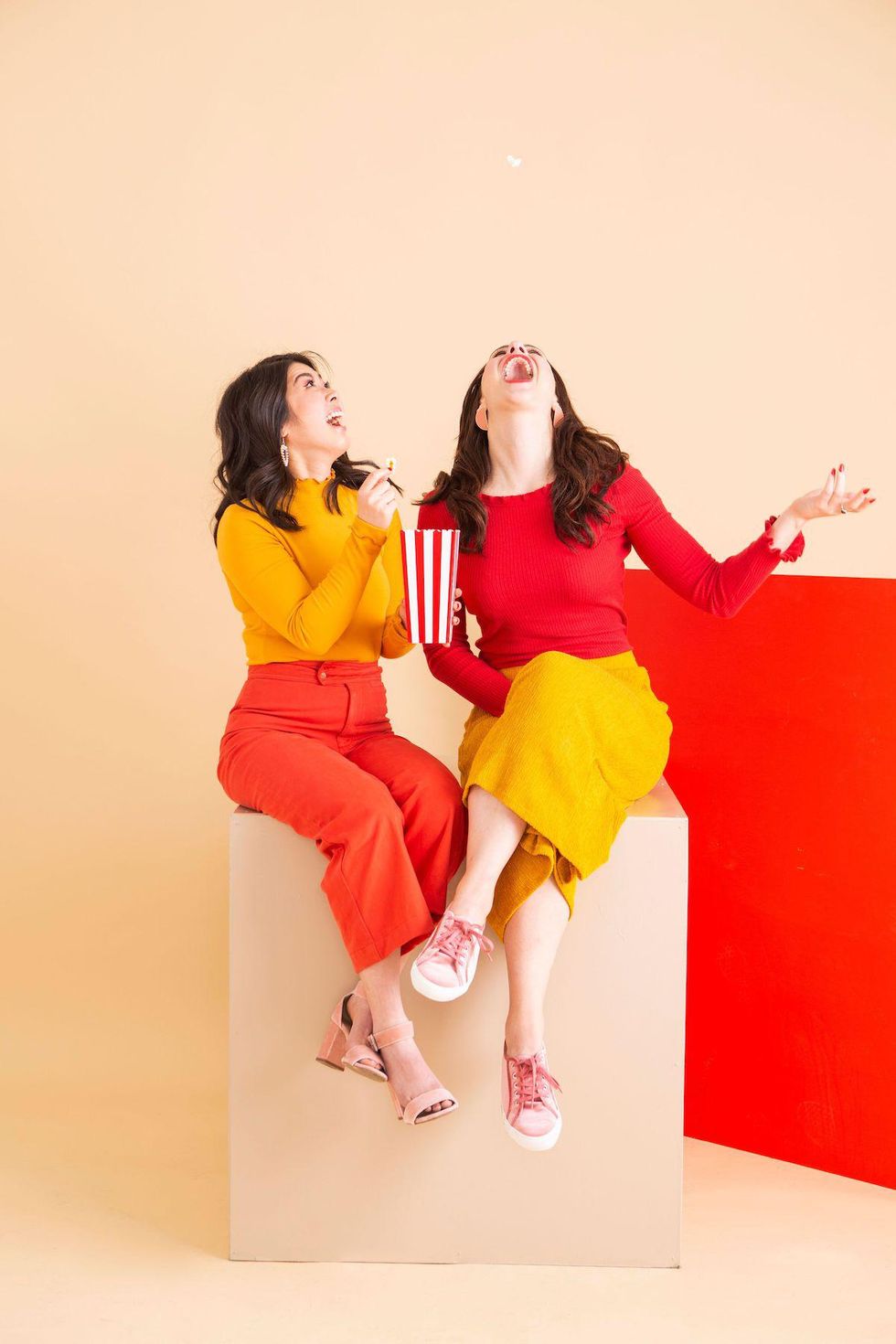 friends laughing and eating popcorn