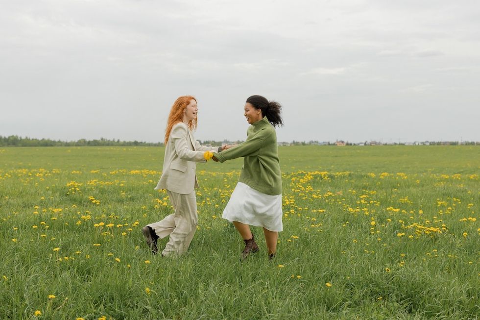 friends running around in the grass