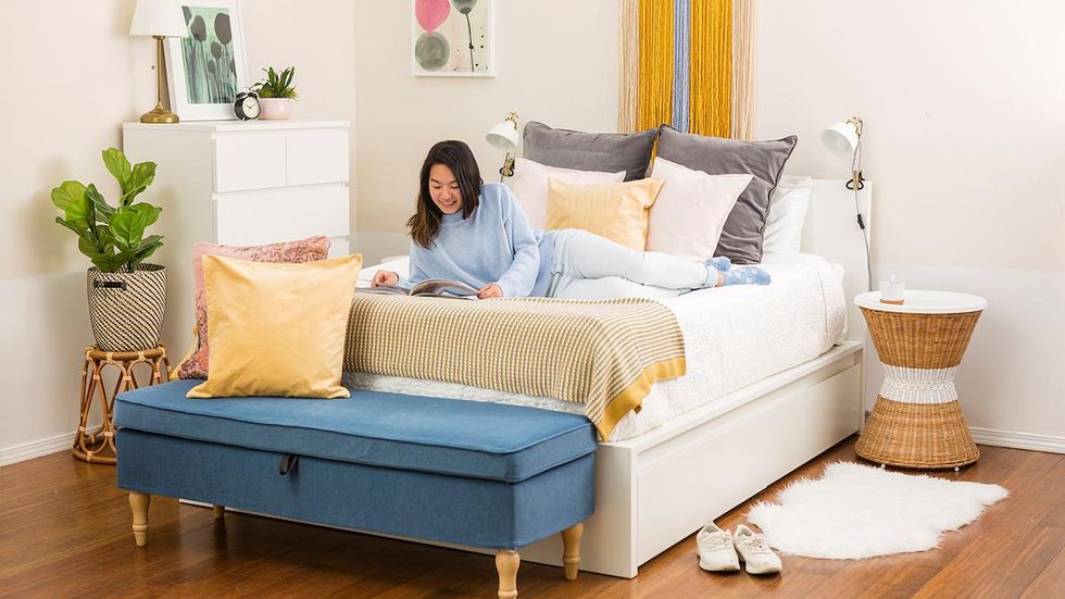 girl laying in bed with a magazine