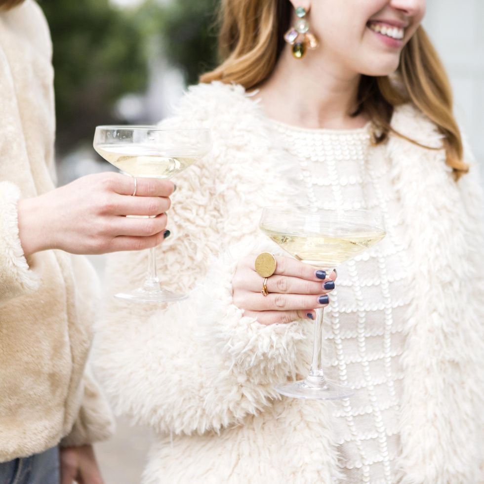 girls holding champagne glasses