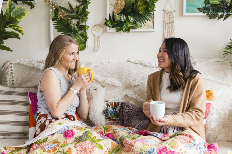 Girls sitting and talking with coffee mugs