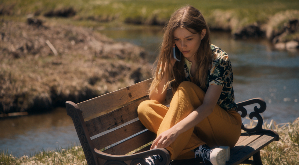 grace van dien in what comes around talking on the phone sitting on a bench