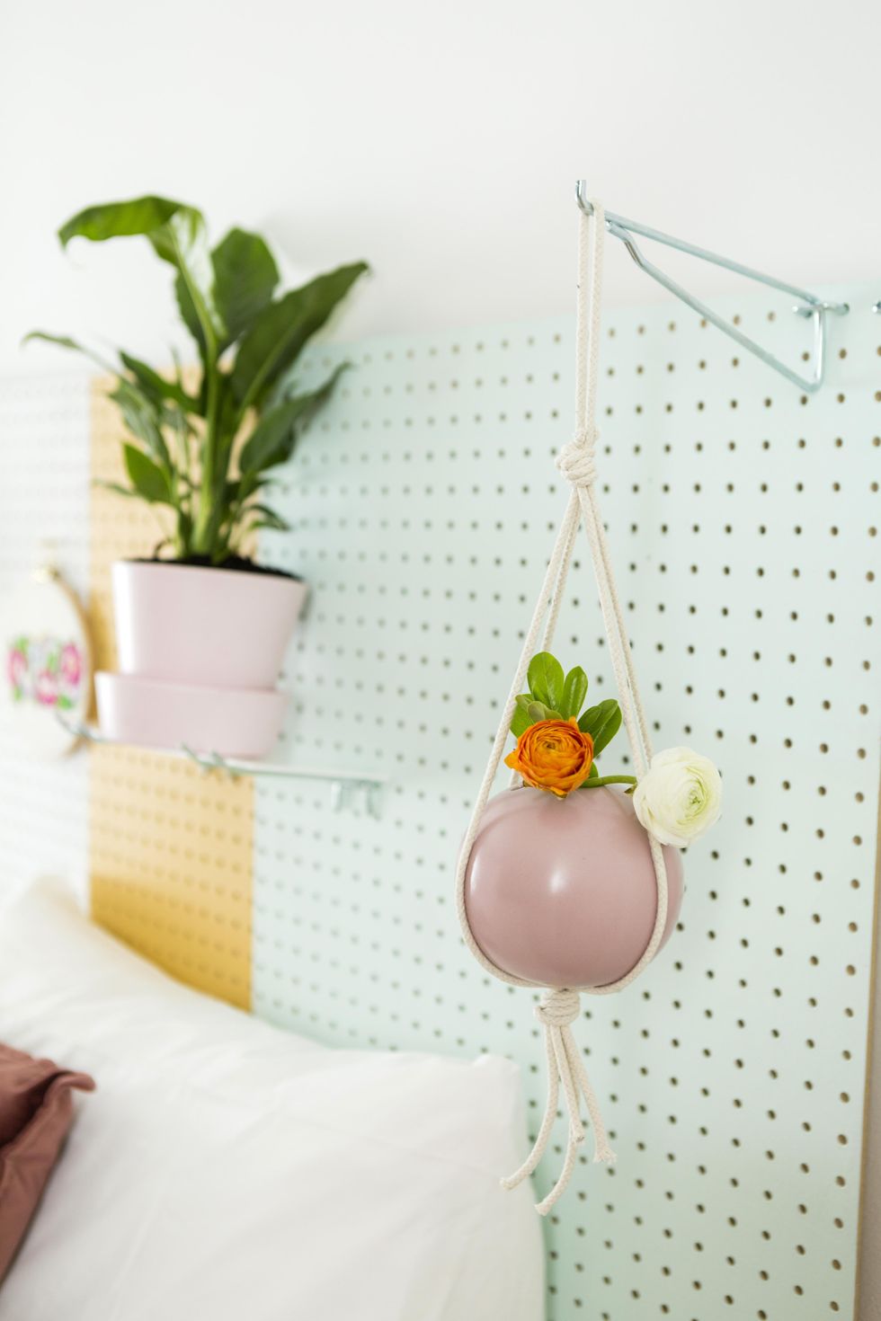 hanging planter on the pegboard headboard