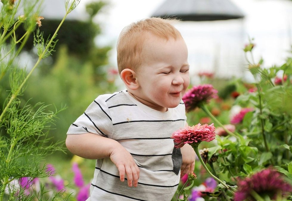 happy baby in a field of flowers