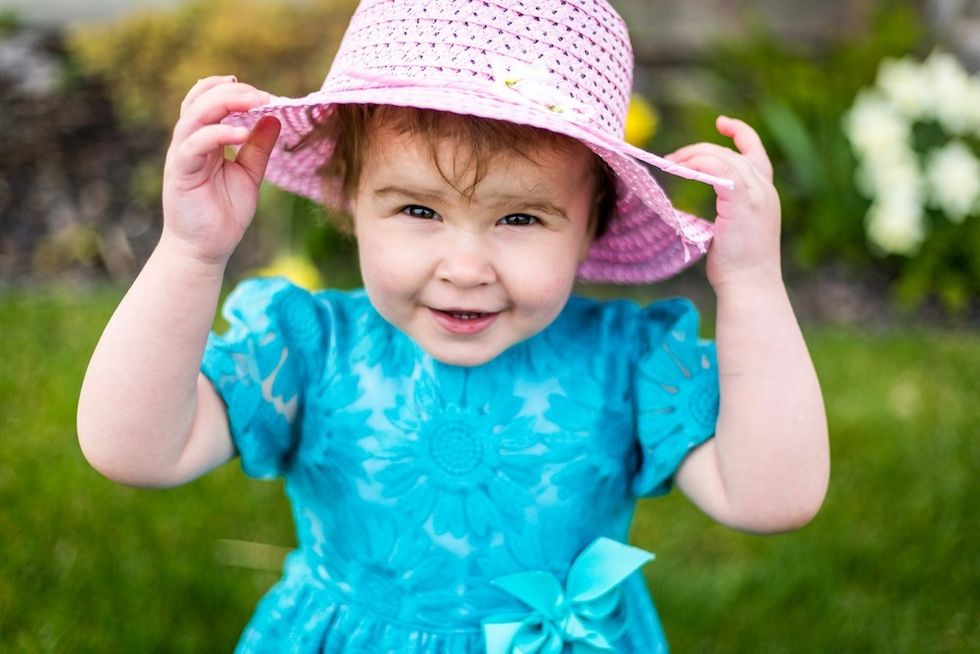 happy baby in a pink hat