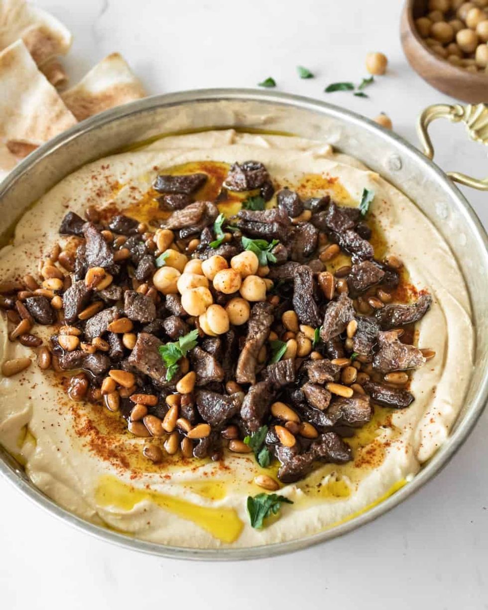 hummus with spiced meat and pine nuts