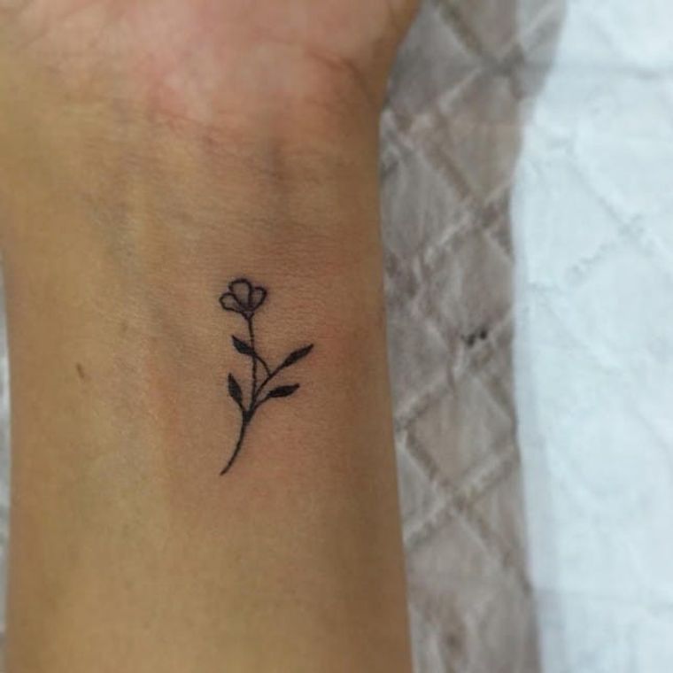 small flower wrist tattoo