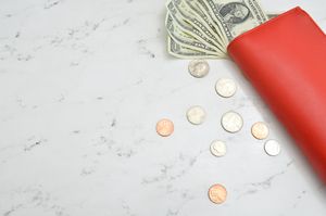 Coins and wallet on table