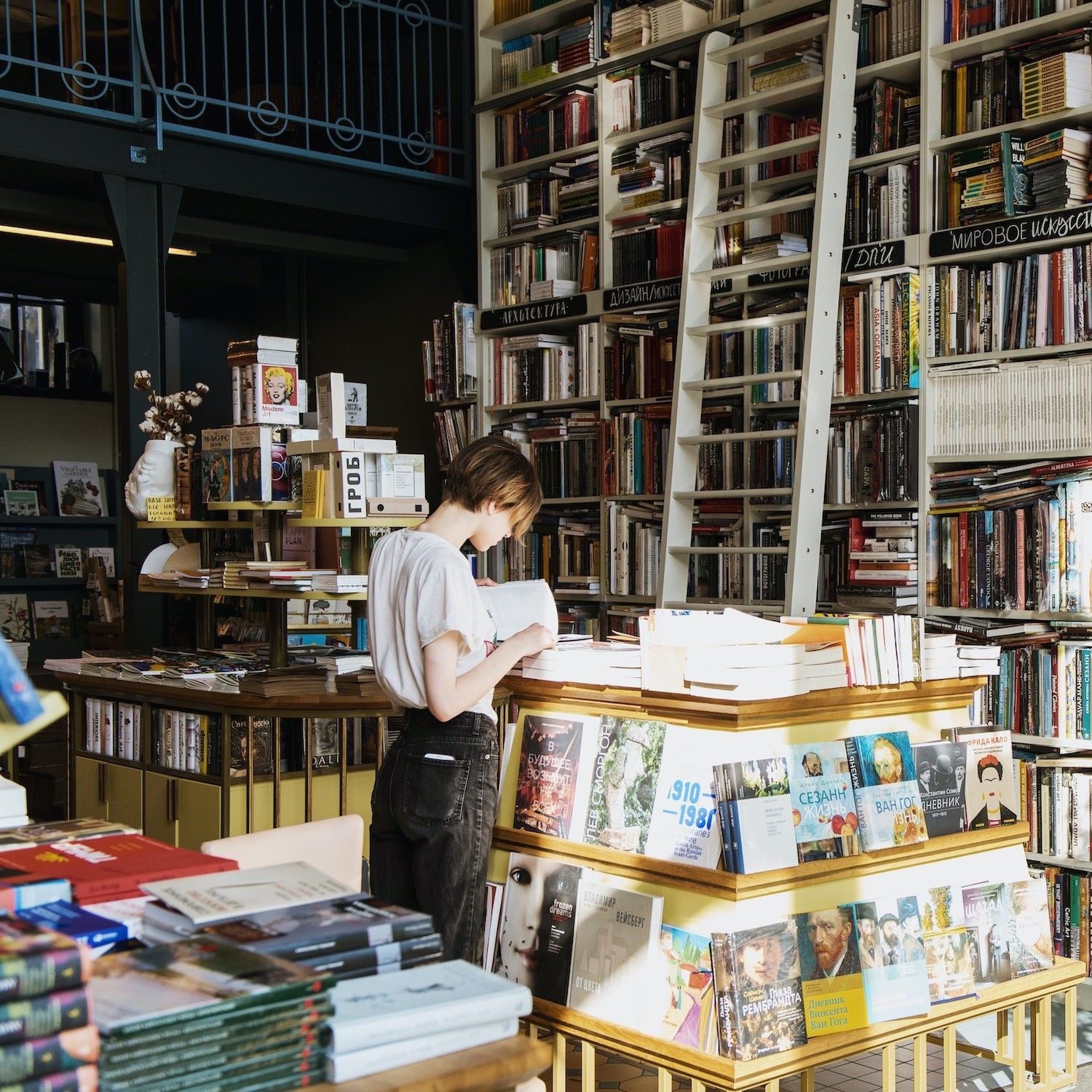 Person perusing bookstores in the sunlight