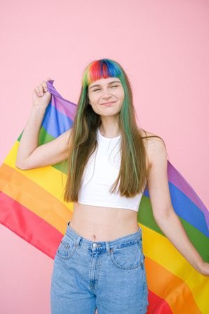 person holding a gay pride flag