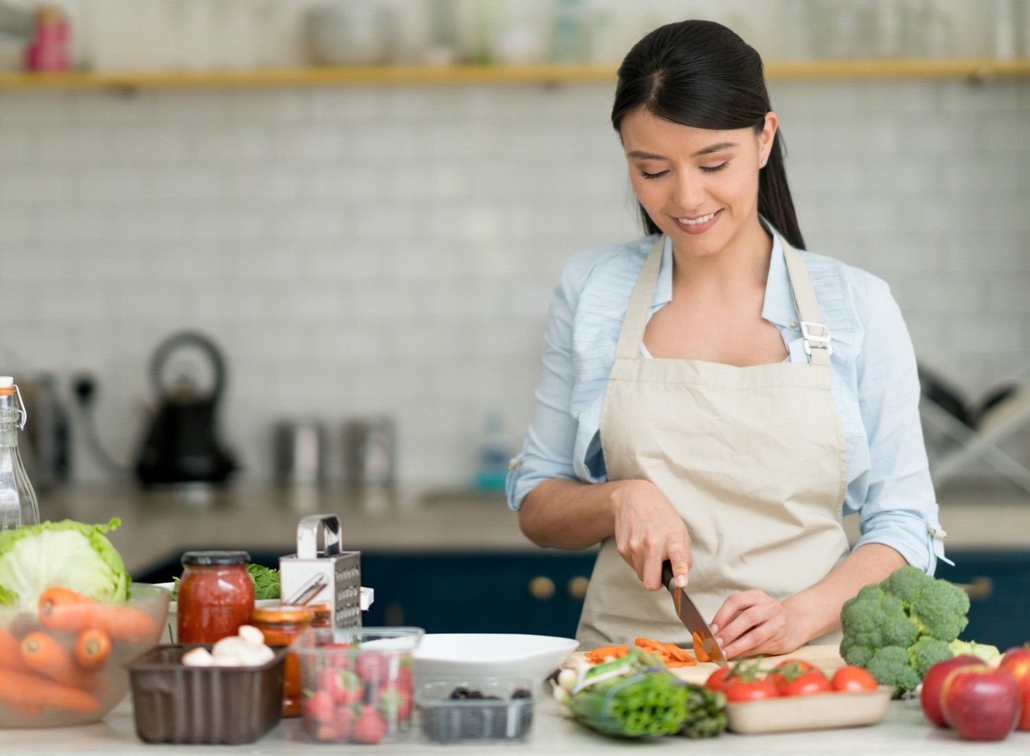 Woman chopping vegetables in the kitchen