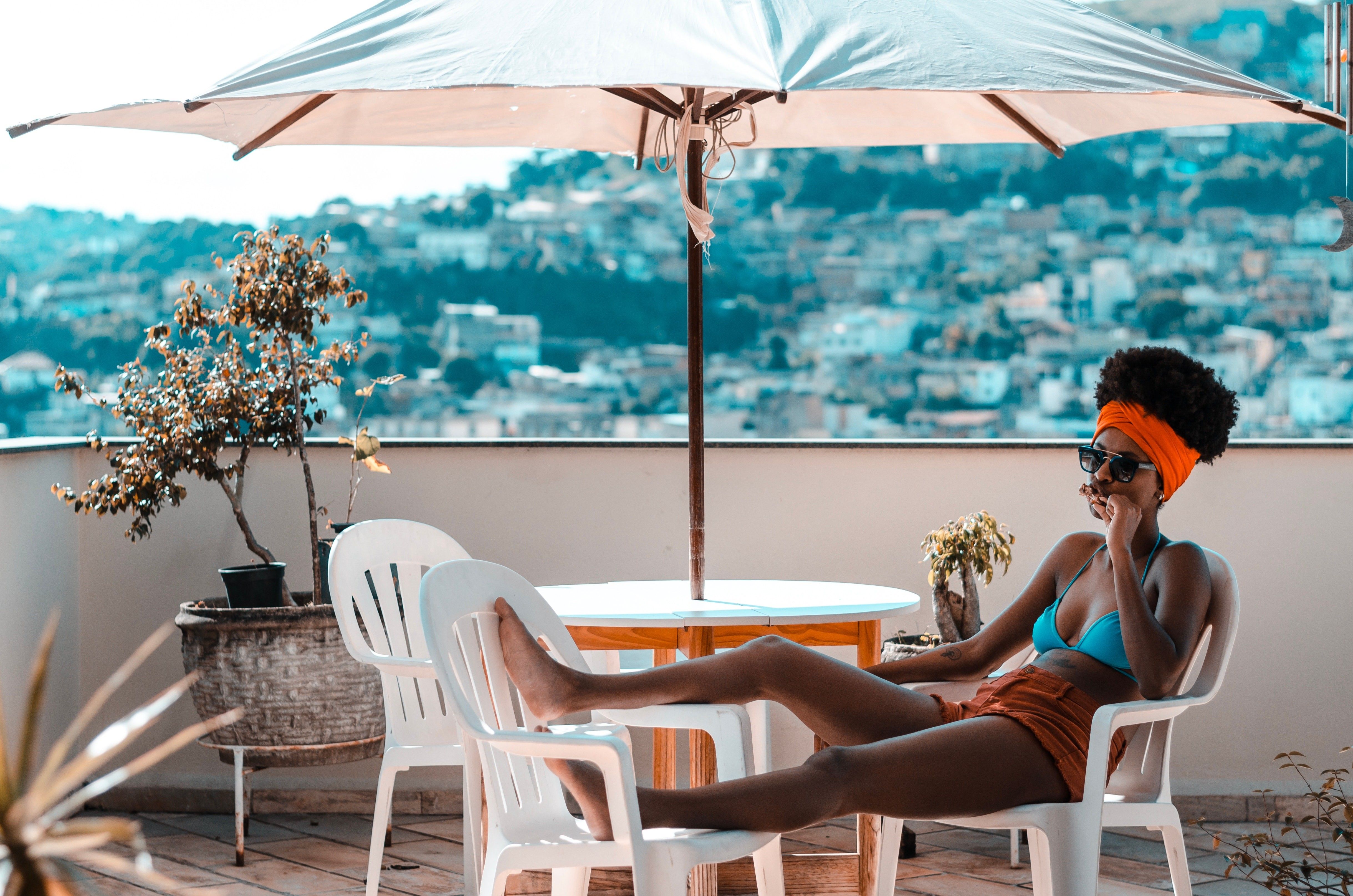 woman sitting in armchair on vacation