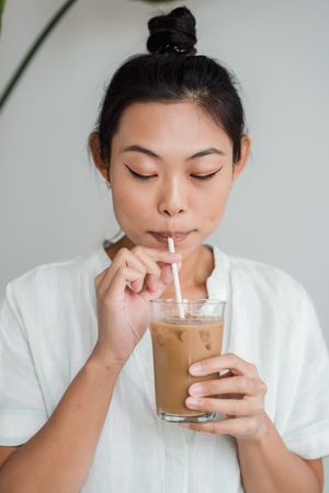 woman drinking an iced coffee dunkin spiked