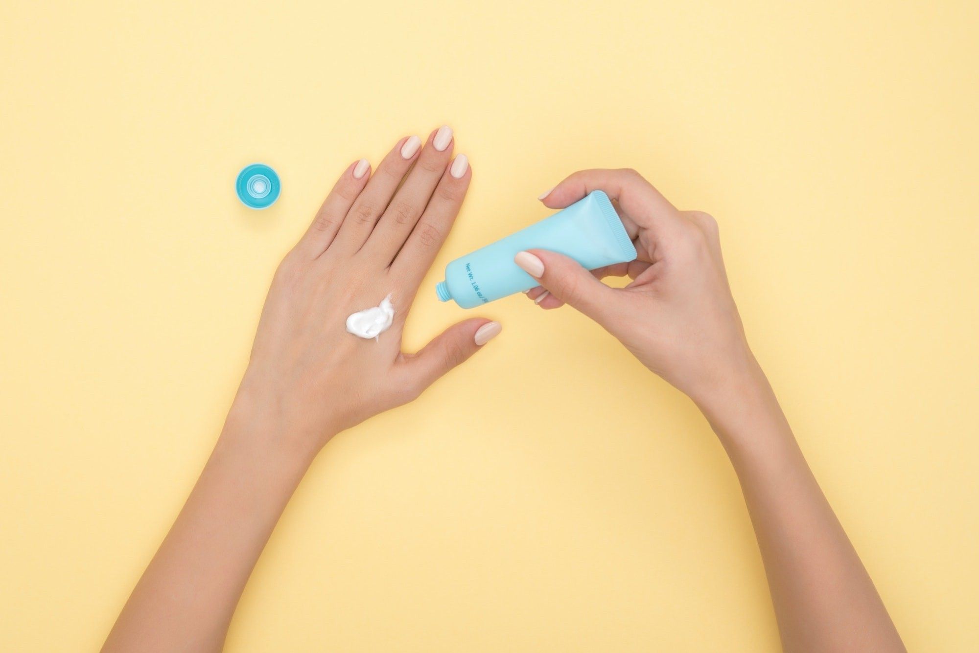 woman applying sunscreen for gel manicure