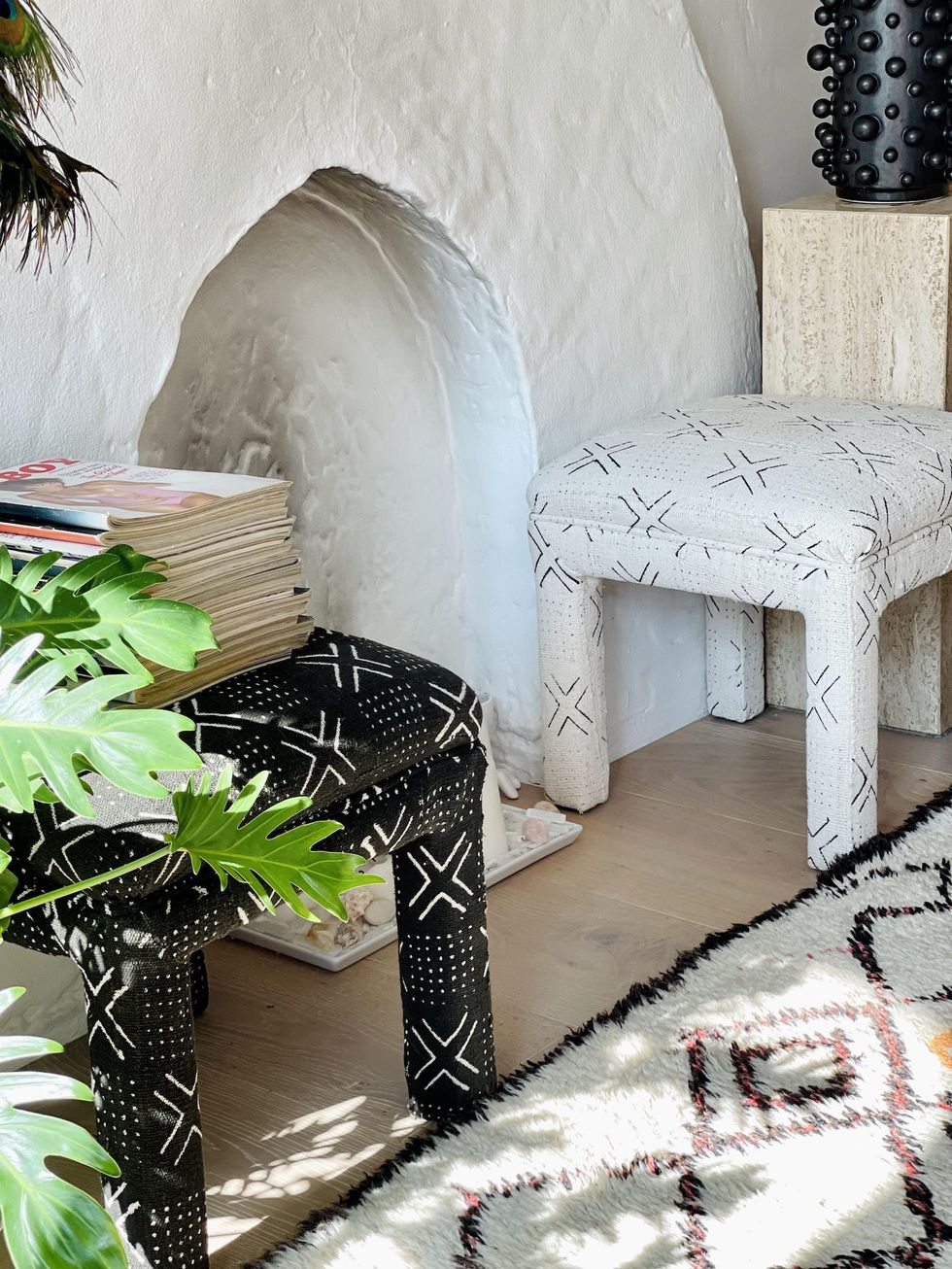 living room area with different textures from stools and a rug