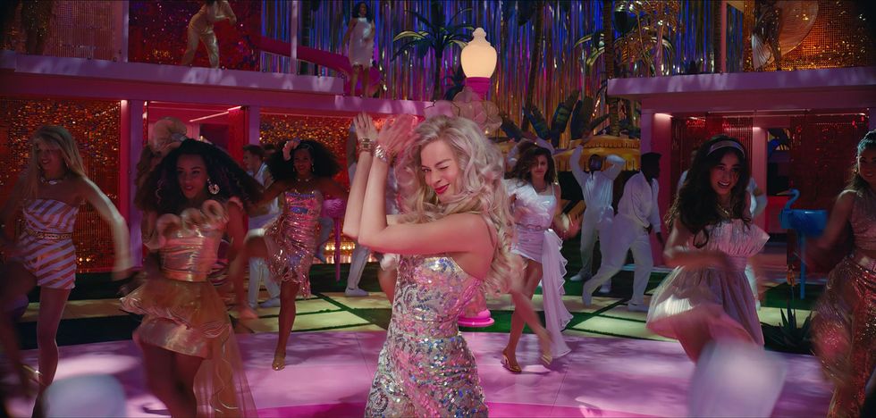 margot robbie as barbie and other characters dancing on a dance floor